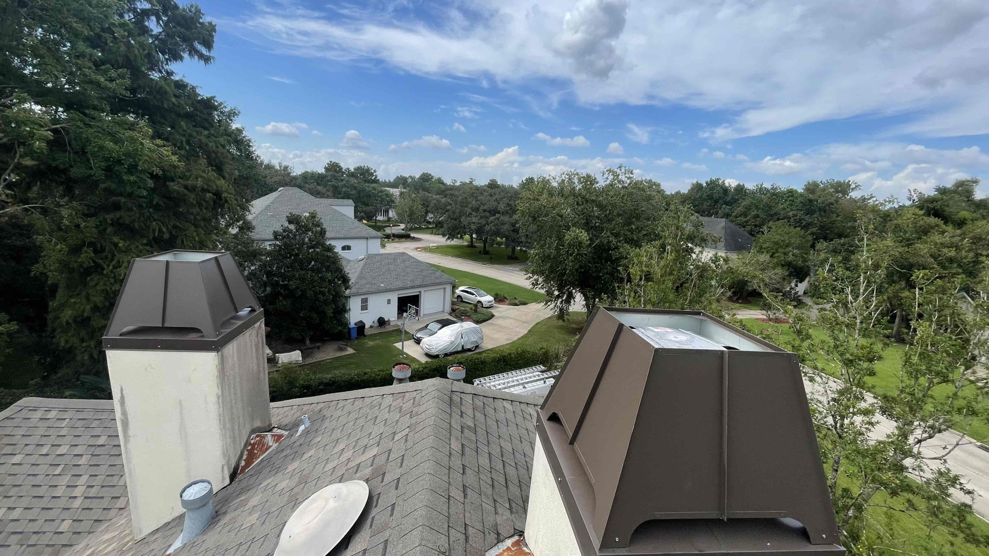 A professional mason performing chimney repair by repointing mortar joints and fixing a cracked crown
